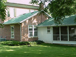 Exterior view from back, showing screened porch and family room